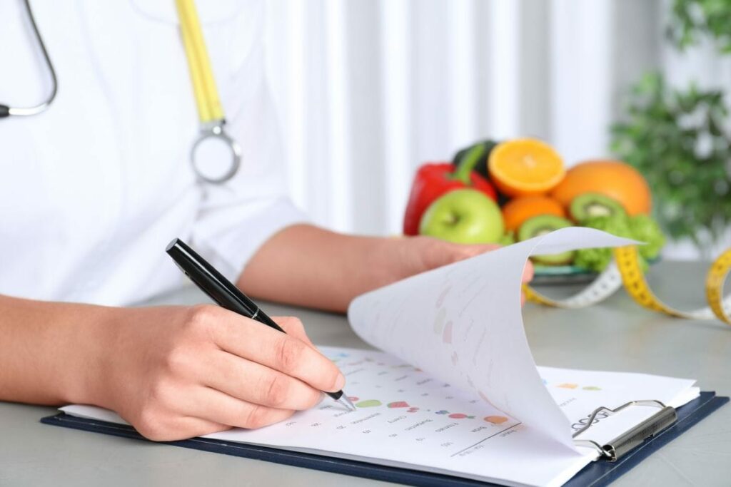 nutritionist writing in a notebook