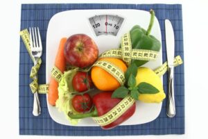 healthy fruits on a scale indicating weight loss